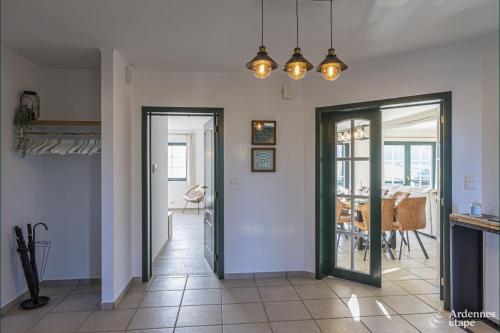 a living room with a door leading to a dining room at Contemporary Villa in Wellin with Private Pool in Wellin