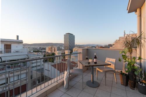 a balcony with a table and chairs and a view at Piraeus City Hotel in Piraeus
