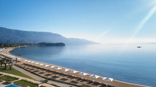 a view of a beach with umbrellas and the water at Ikos Dassia in Dassia