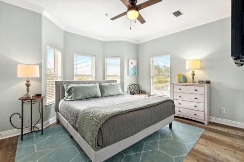 a bedroom with a bed and a ceiling fan at Rockaway Beach in Santa Rosa Beach