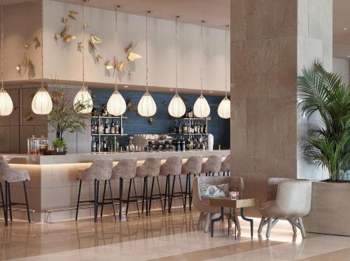 a restaurant with a bar with bar stools at Ikos Dassia in Dassia