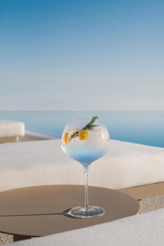 a cocktail in a glass on a table at Ikos Dassia in Dassia