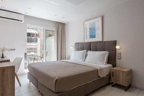 a bedroom with a large bed and a balcony at Piraeus City Hotel in Piraeus