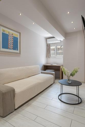 a living room with a couch and a table at Piraeus City Hotel in Piraeus