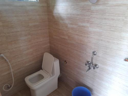 a bathroom with a toilet and a sink at Adithyanaman Cottage Homestay in Darjeeling