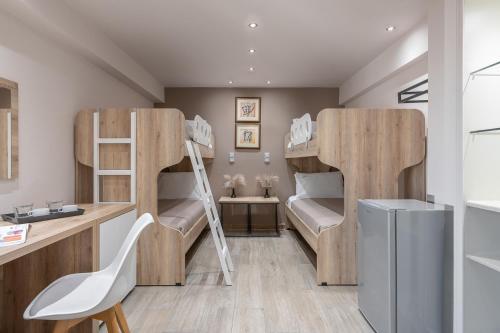 a room with two bunk beds and a desk at Piraeus City Hotel in Piraeus