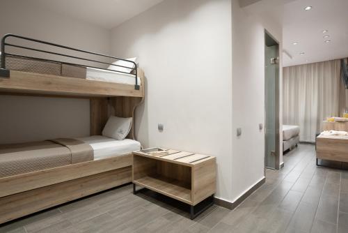 a room with two bunk beds and a table at Piraeus City Hotel in Piraeus