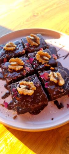 a plate of chocolate cake with nuts on it at Bumi Cinta Bali in Tejakula