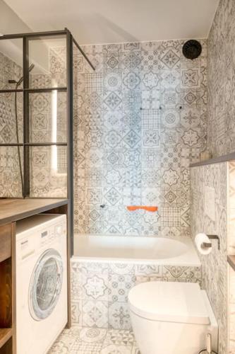 a bathroom with a toilet and a washing machine at Seaside Haven for 6 with Parking in Knokke in Heist