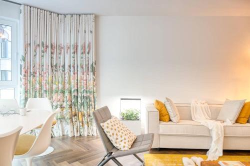 a living room with a couch and a table at Seaside Haven for 6 with Parking in Knokke in Heist