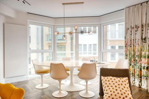 a dining room with a table and chairs at Seaside Haven for 6 with Parking in Knokke in Heist