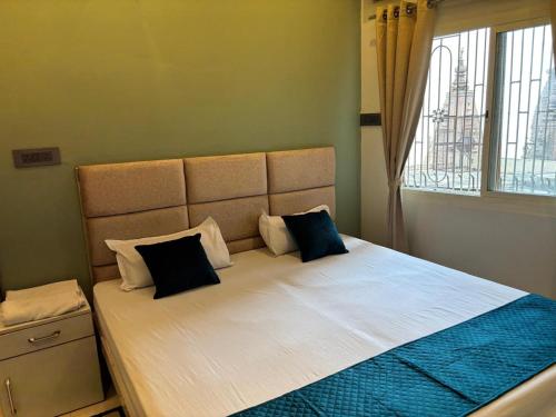 a bed with two pillows on it in a bedroom at Bhadra Kali Guest House in Varanasi