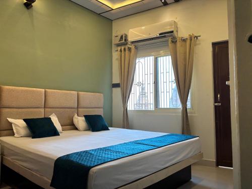 a bedroom with a large bed with a window at Bhadra Kali Guest House in Varanasi