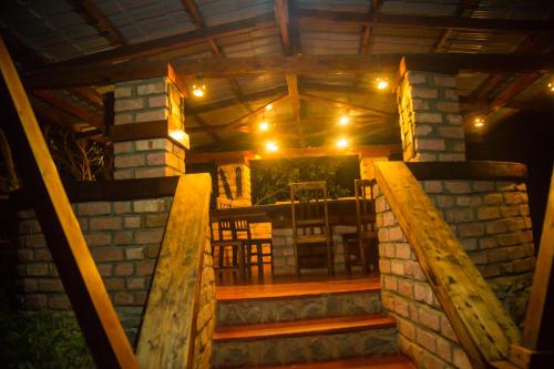 an outside view of a house with a table and chairs at Swiss Farm Cottage in Lushoto