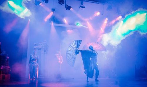 a group of people on a stage holding umbrellas at Ikos Dassia in Dassia