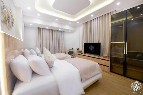 Una televisión o centro de entretenimiento en Arabella Residence