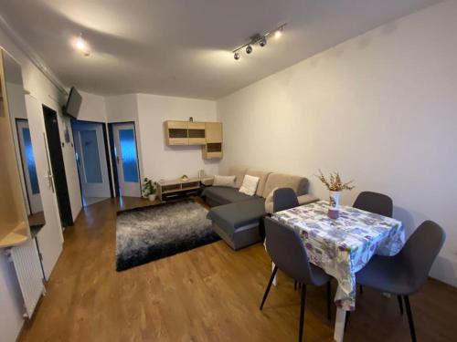 a living room with a table and a couch at Mary's City Room in Nyíregyháza