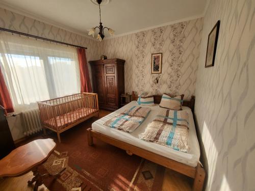 a small bedroom with a bed and a chair at Erika Apartman in Balatonlelle