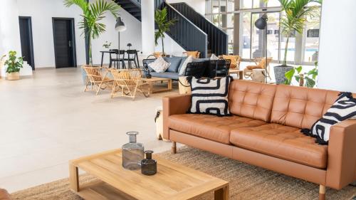 a living room with a couch and a table at Coral Cotillo Beach in Cotillo