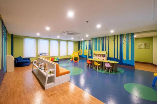 a childrens room with a play area with a table and chairs at Uptown BGC in Manila