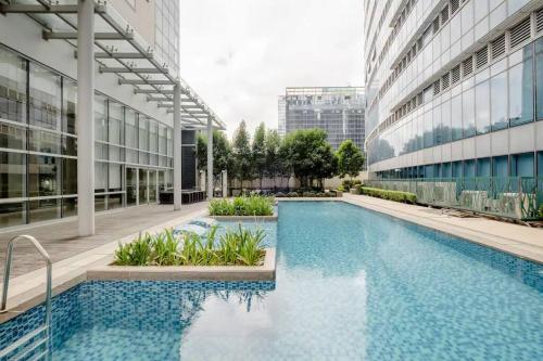a swimming pool in the middle of a building at Uptown BGC in Manila