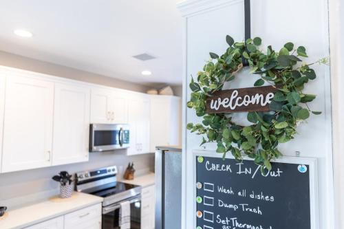 a kitchen with a welcome sign on a refrigerator at Comfy and Stylish 4 Bathrooms 26 in Ridgecrest