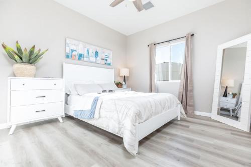 a white bedroom with a white bed and a window at Comfy and Stylish 4 Bathrooms 26 in Ridgecrest