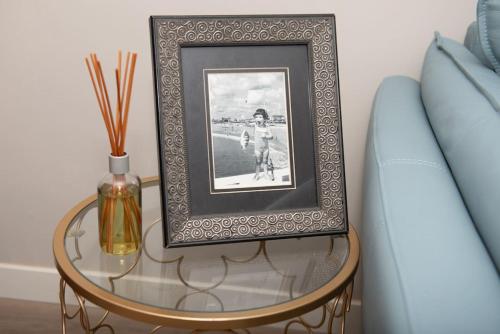 a table with a picture on it next to a couch at Dragonfly Beach Retreat in Grayland