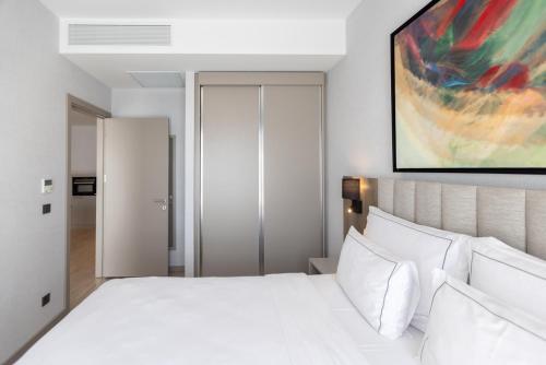 a bedroom with a large white bed with white pillows at Antwell Suites in Istanbul