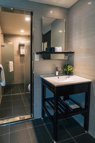a bathroom with a sink and a shower at Hotel Puri in Taipei