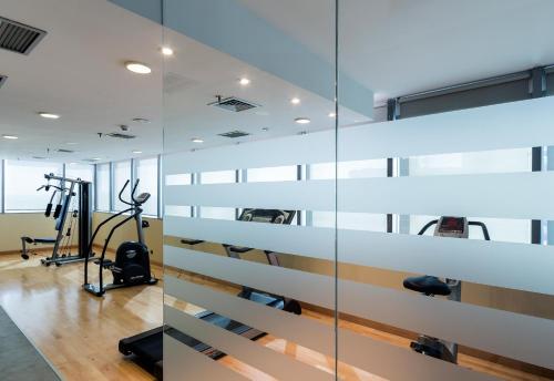 a gym with glass walls and tread machines at LCB Hotel Fuenlabrada in Fuenlabrada