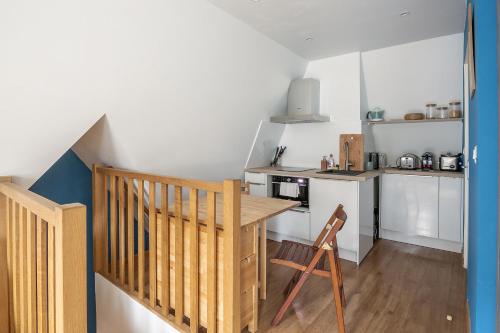une petite cuisine avec une table en bois et un comptoir dans l'établissement La Cabane Malouine, à Saint-Malo