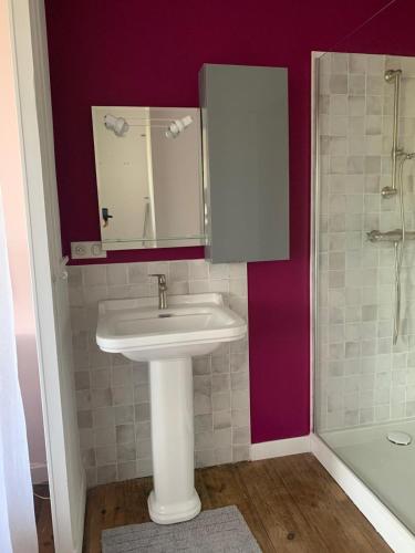 a bathroom with a sink and a shower at La Poésie in Lagor