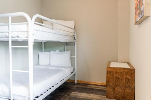 a bedroom with two bunk beds and a table at Aloha Beach Resort in Wisconsin Dells