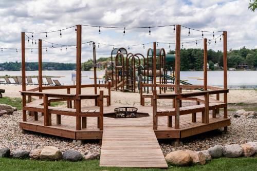 a park with a playground with a wooden bridge at Aloha Beach Resort in Wisconsin Dells