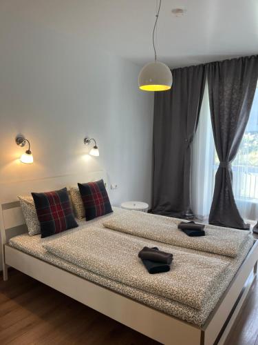 a bed in a room with a large window at Near Ozas in Vilnius