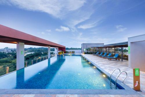 a swimming pool on the roof of a building at ibis Styles Mysuru in Mysore