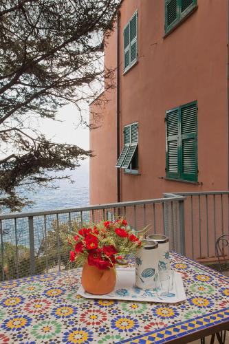 a table with a vase of flowers sitting on a table at Bed & Breakfast Cas'Alda in Varazze