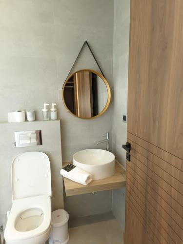 a bathroom with a sink and a toilet and a mirror at Villa Elia in Tamaris