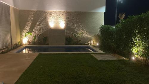a backyard with a swimming pool at night with lights at Villa Elia in Tamaris