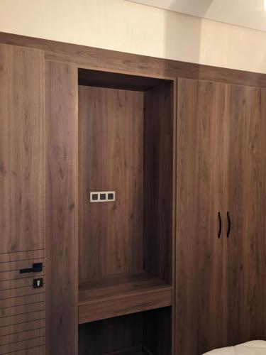 a wooden cabinet in a room with a bed at Villa Elia in Tamaris