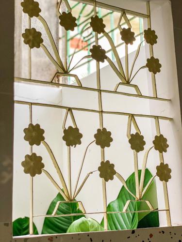 a shelf with three vases with flowers in them at DƯỚI TÁN CÂY homestay in Tây Ninh