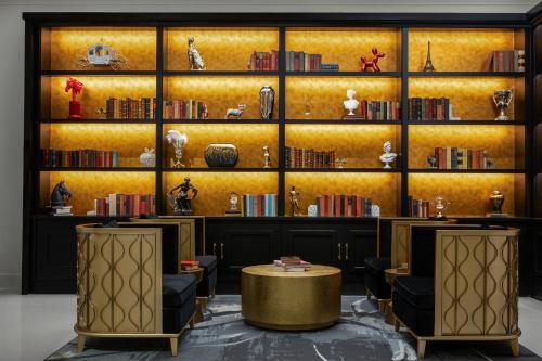 a room with bookshelves and a table and chairs at The Admiral, Downtown Historic District in Mobile
