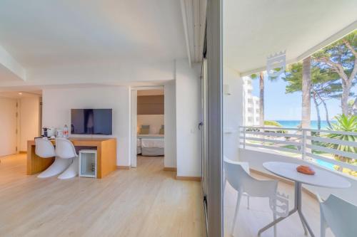 a living room with a view of the ocean at Playa Esperanza Resort Affiliated by Meliá in Playa de Muro