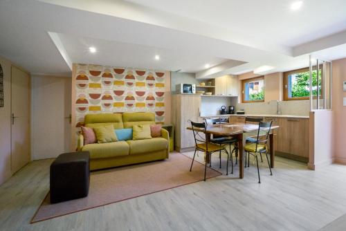 a living room with a yellow couch and a table at Chez Anna in Saint-Jean-de-Maurienne