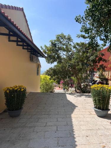 a brick walkway next to a building with plants at The mountain Sea View in Vung Tau