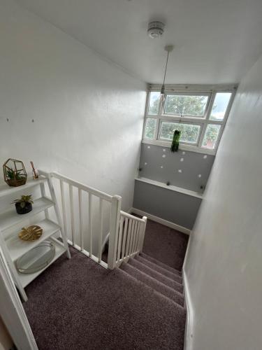 a room with a stairs with a window and a stair case at 1 bedroom house, Seven Sisters, Tottenham in London