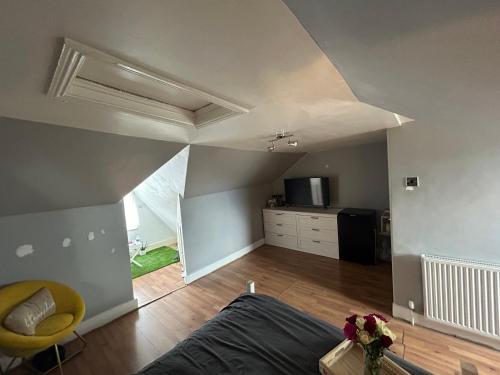 a living room with a bed and a kitchen at 1 bedroom house, Seven Sisters, Tottenham in London
