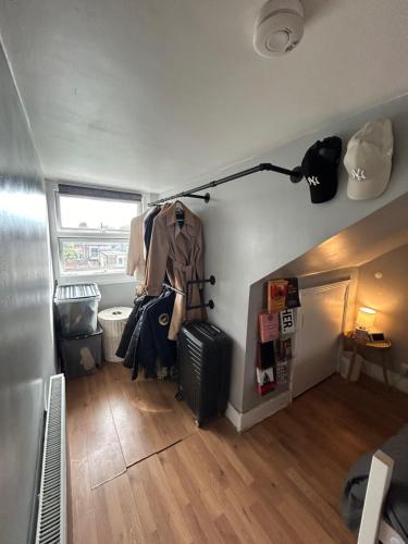 a room with a clothes rack and a refrigerator at 1 bedroom house, Seven Sisters, Tottenham in London