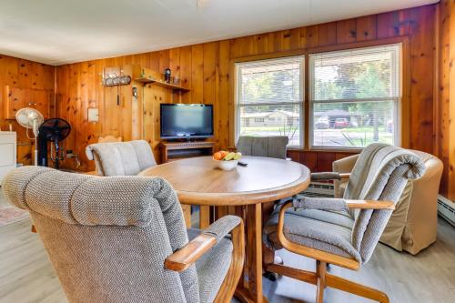 a dining room with a table and chairs and a television at Home about 17 Mi to Detroit with Patio and Grill! in Southfield